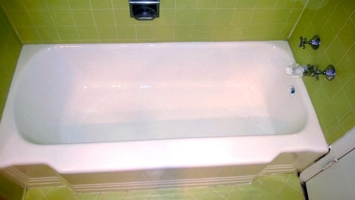 Refinished 1949 bathtub with green tile splash and floot